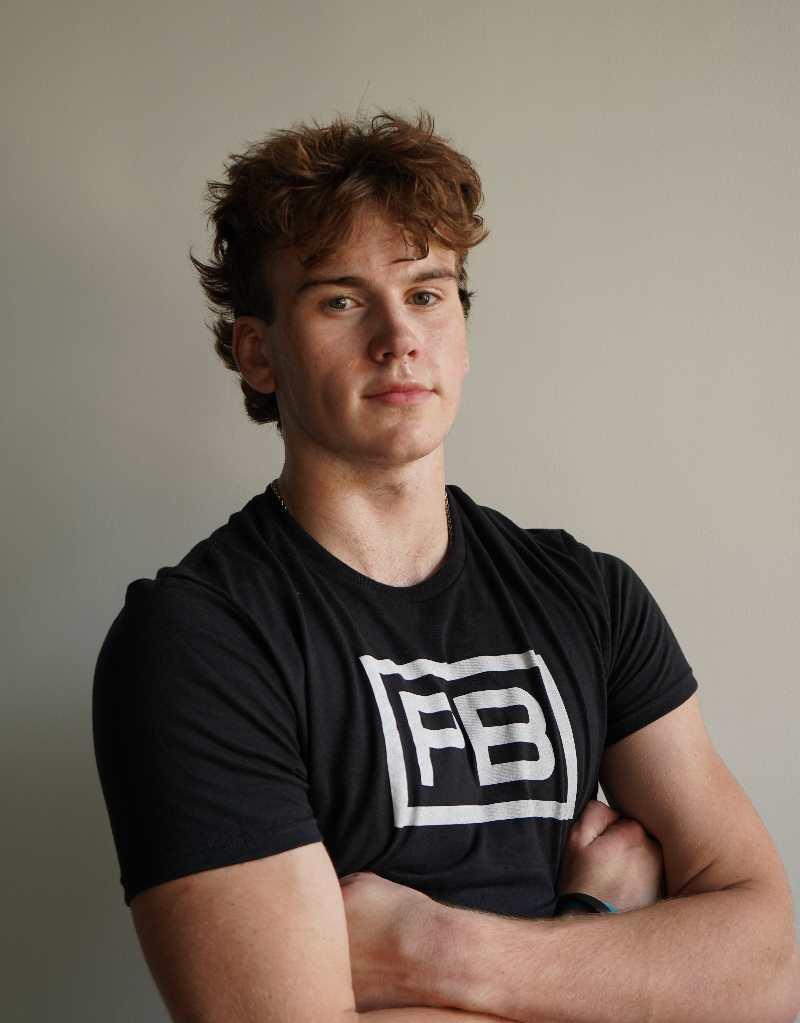 A headshot of PowerBlock fitness studio coach Charlie Thorpe wearing a black powerblock shirt.