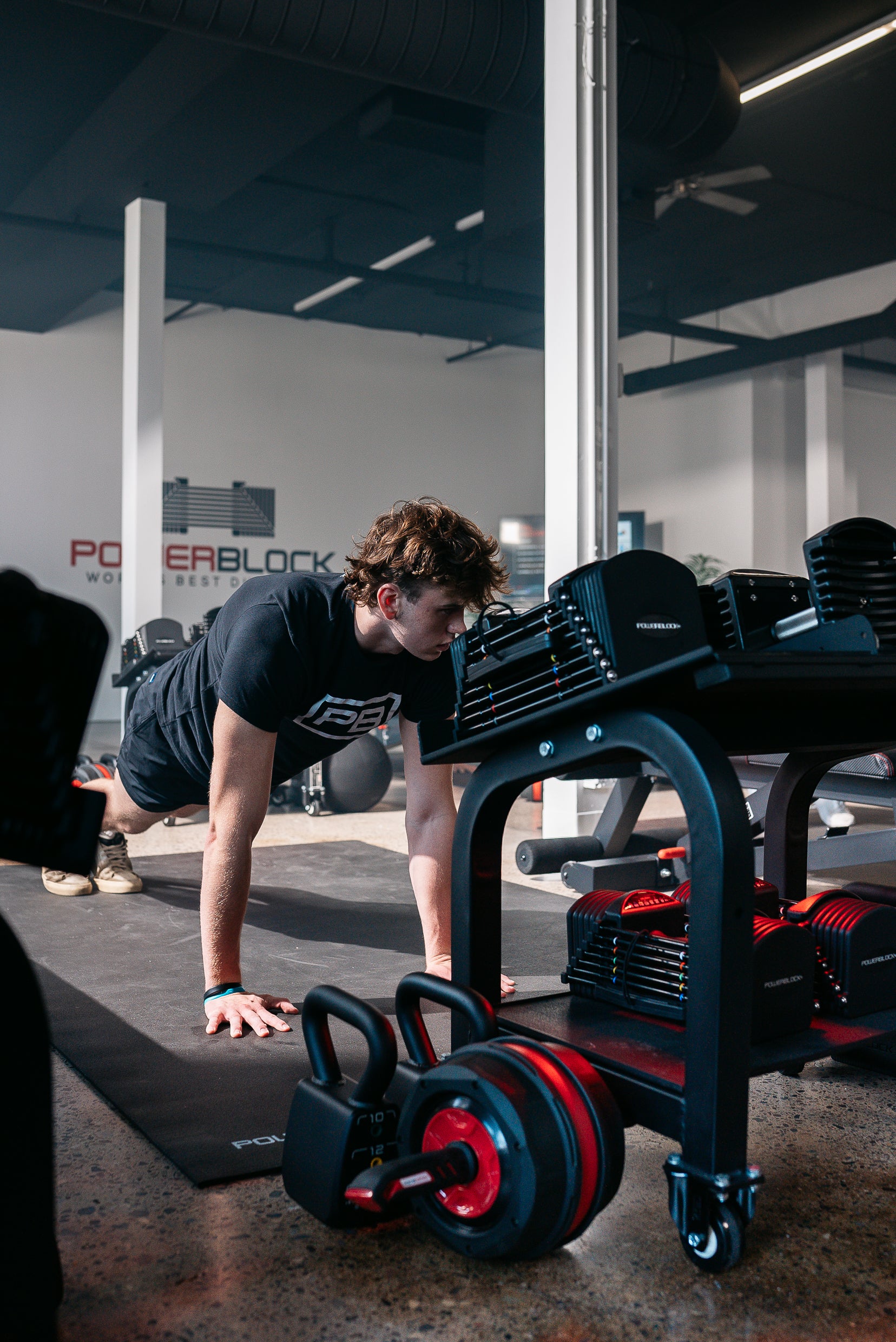a powerblock fitness studio member doing bodyweight planks.