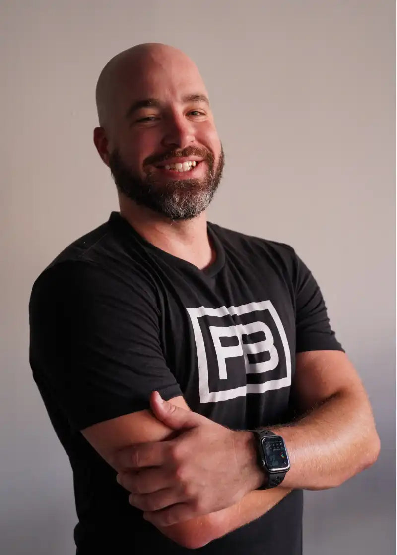 powerblock fitness studio coach Ben Lucius smiling for a headshot photo.
